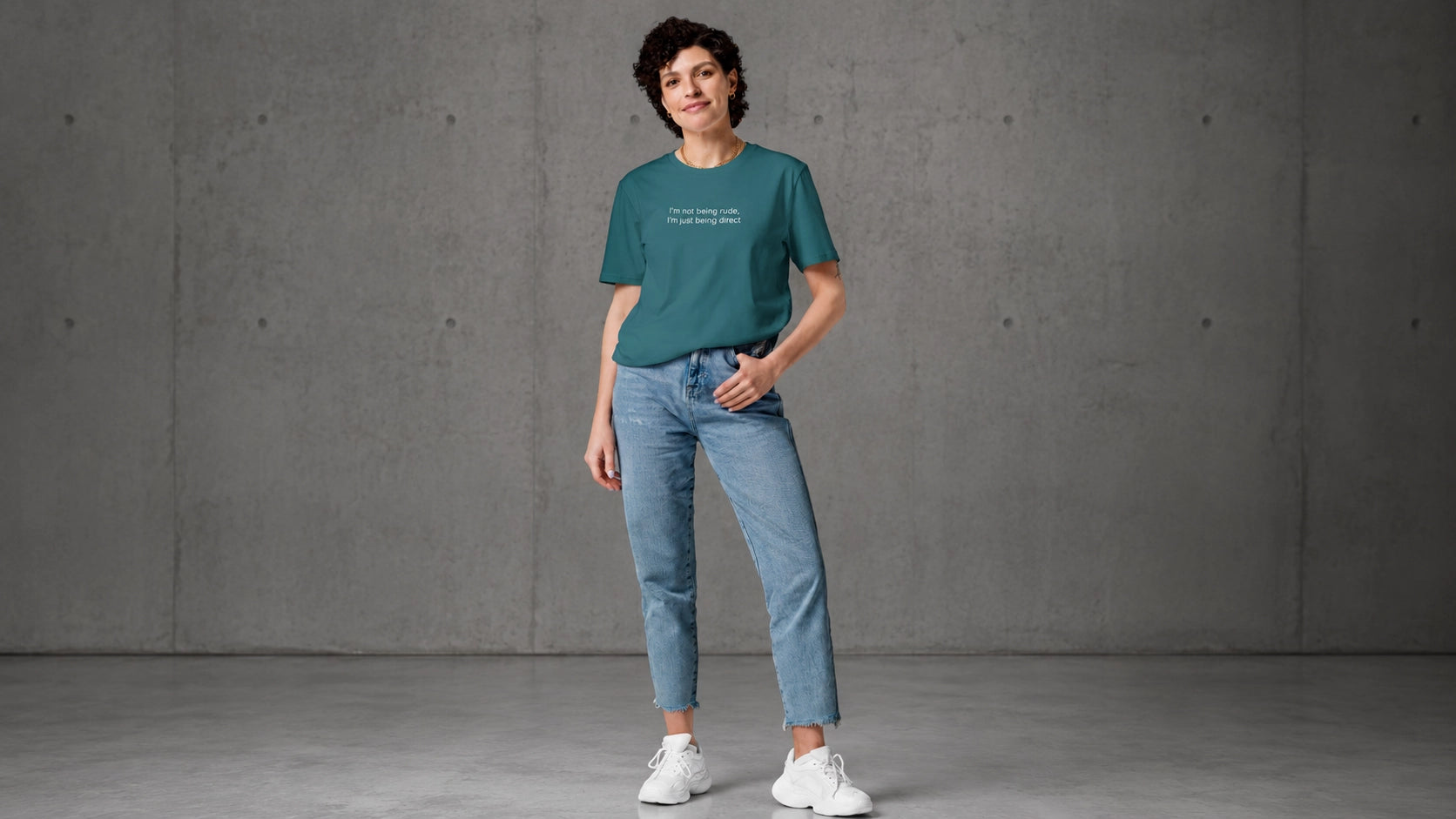 Woman wearing an I'm not being rude t-shirt standing against a gray concrete wall.